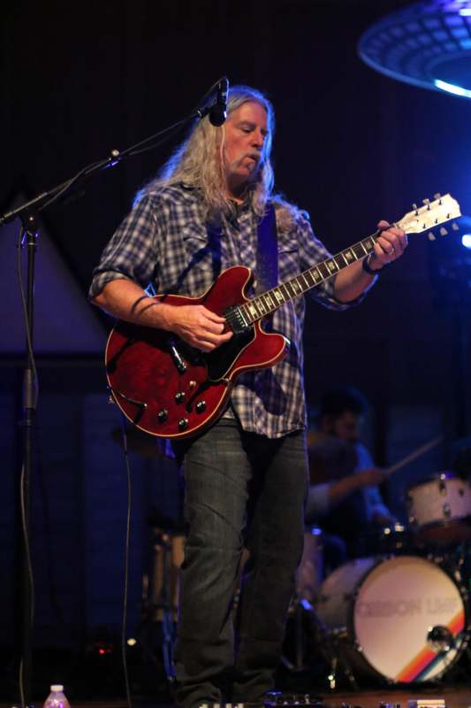 a man playing a guitar on a stage