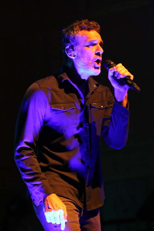 a man singing into a microphone