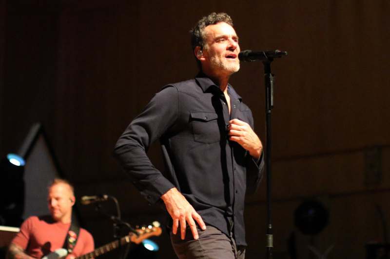 a man singing into a microphone