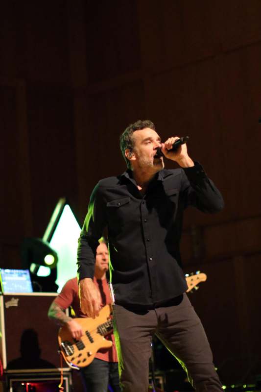 a man singing into a microphone