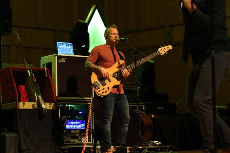 a man playing a guitar on a stage
