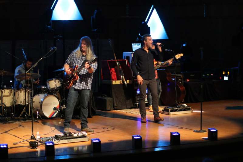 a group of men on a stage playing instruments