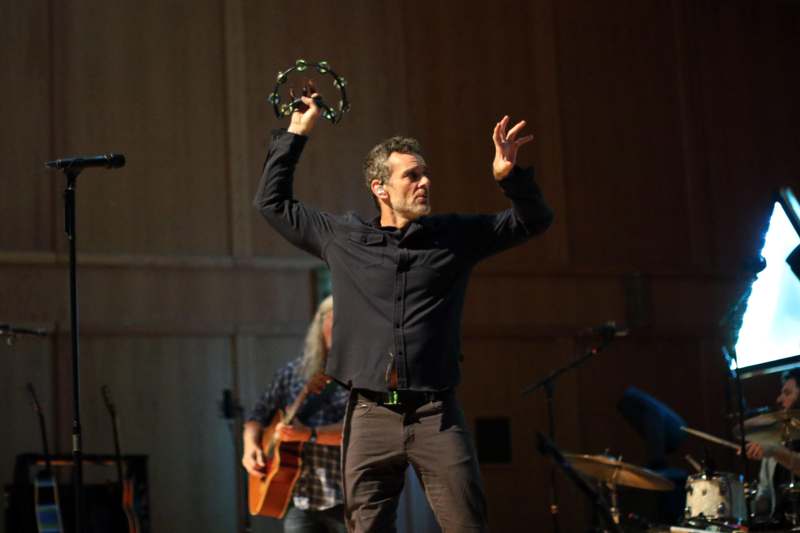 a man holding a tambourine in his hand