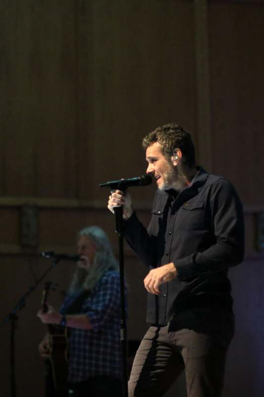 a man singing into a microphone