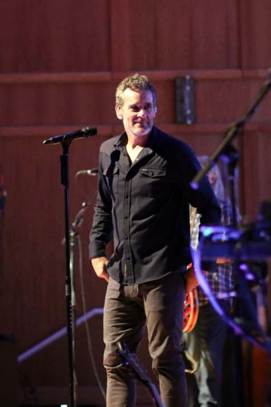 a man standing on a stage with a microphone