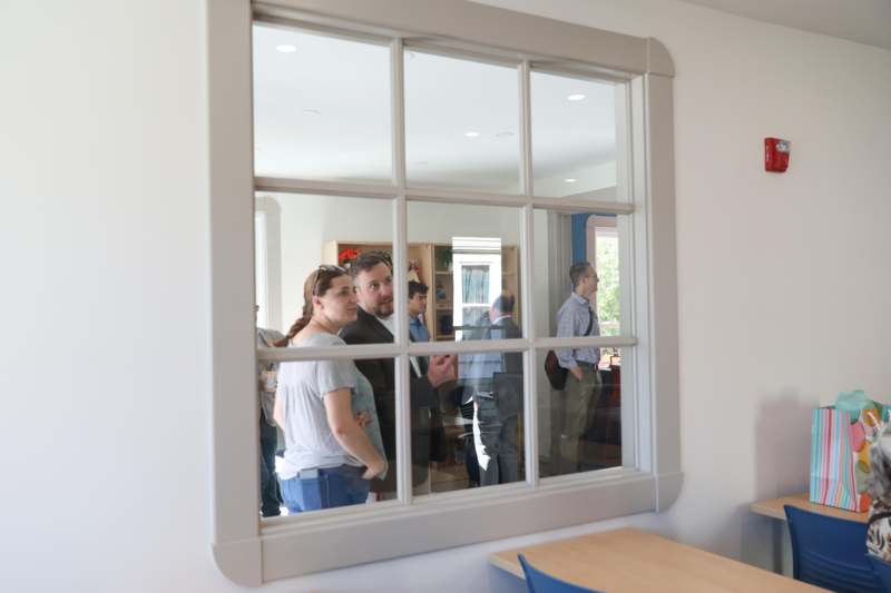 a group of people looking through a window