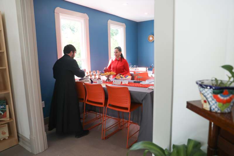 a man and woman standing at a table