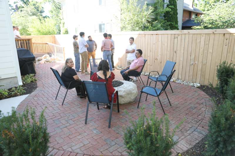 a group of people sitting around a fire pit