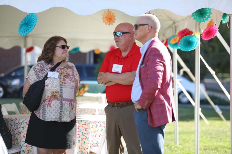 a group of people standing under a tent