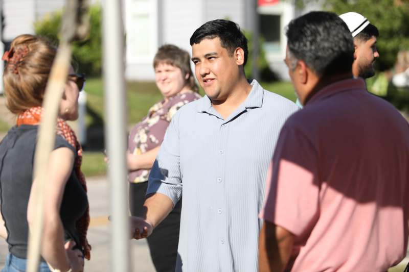a man shaking hands with other people