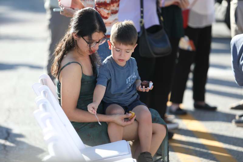 a woman and a child sitting on a chair