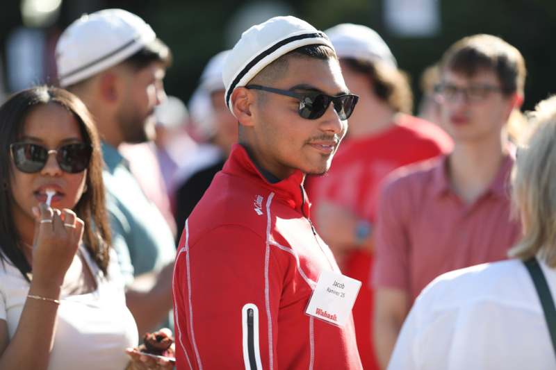 a man in a red shirt and white hat