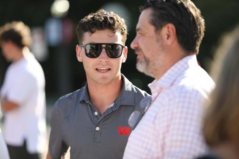 a man in sunglasses looking at another man in sunglasses