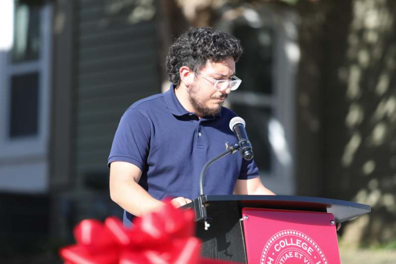 a man standing at a podium with a microphone