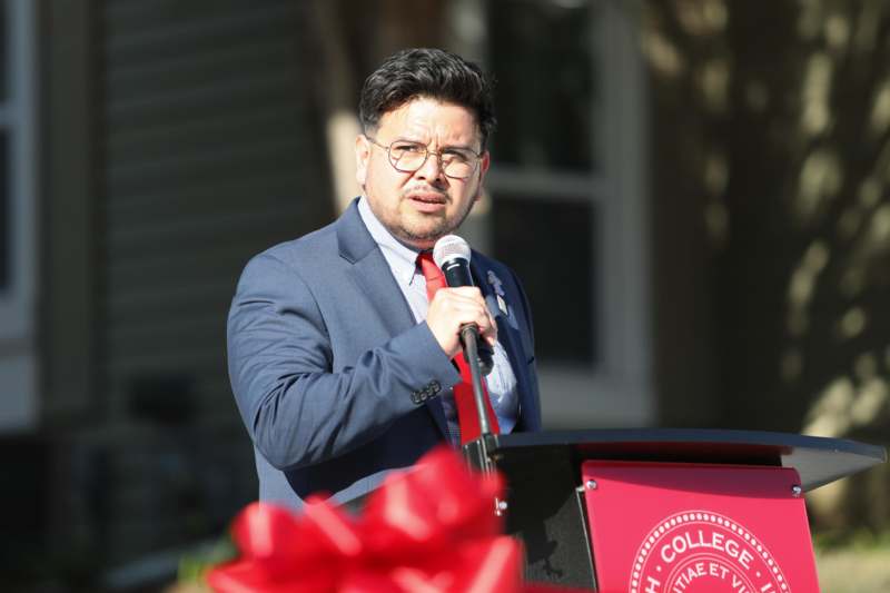 a man in a suit speaking into a microphone