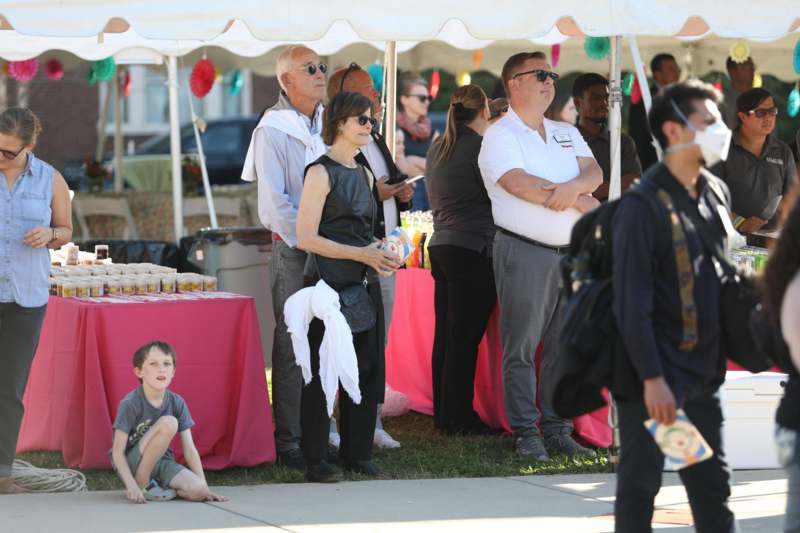 a group of people standing under a tent