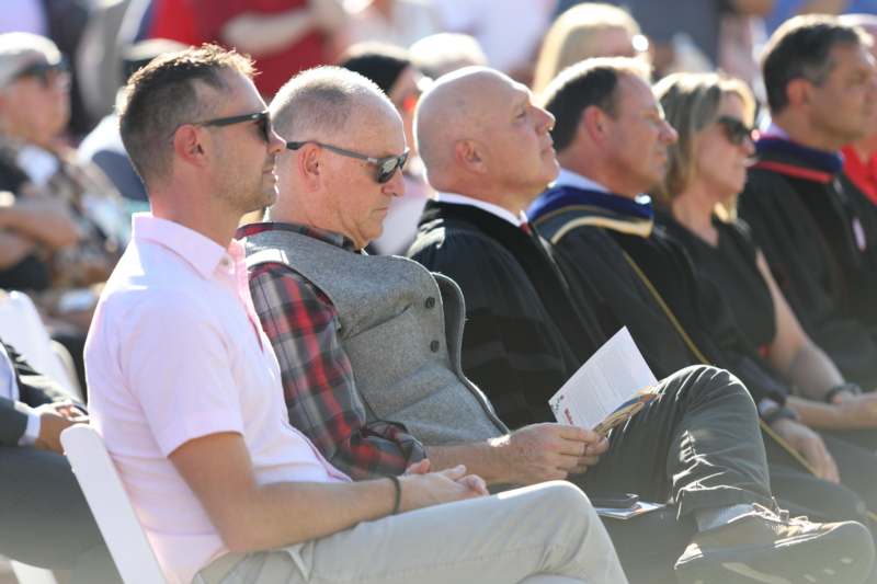 a group of people sitting in a row