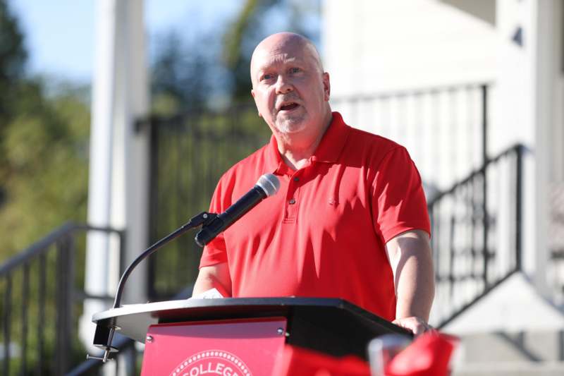 a man standing at a podium with a microphone