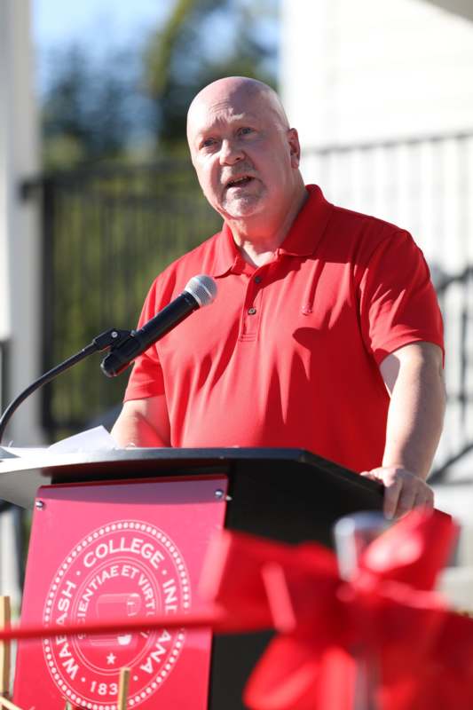 a man standing at a podium with a microphone