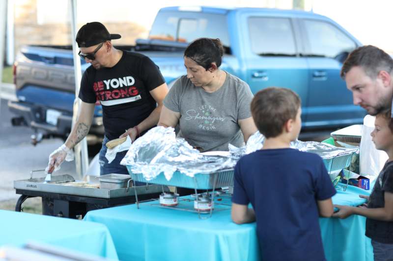 a group of people at a food stand