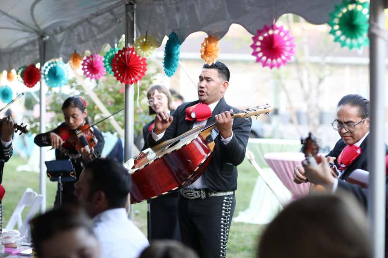 a group of people playing instruments under a tent