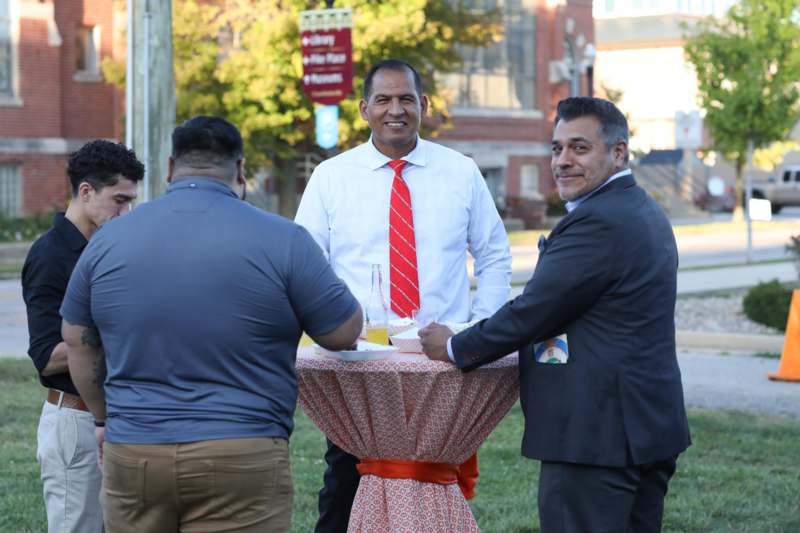 a group of men standing around a table