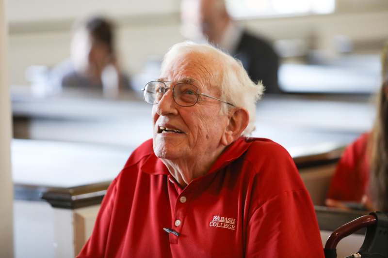 an old man in a red shirt