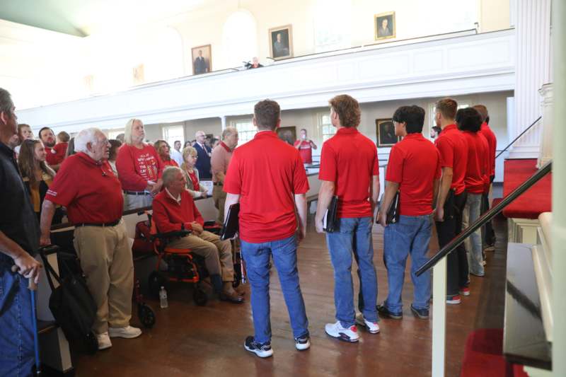 a group of people in red shirts