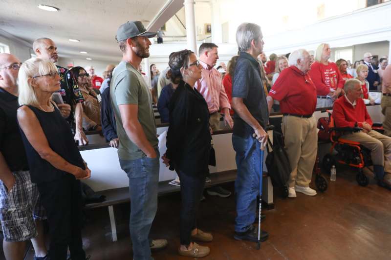 a group of people standing in a row
