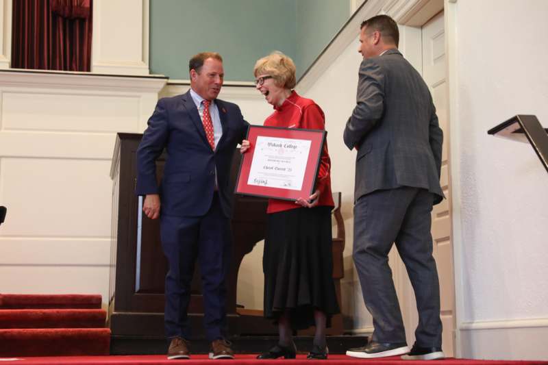 a man and woman holding a certificate