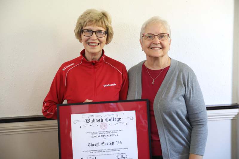 two women holding a certificate