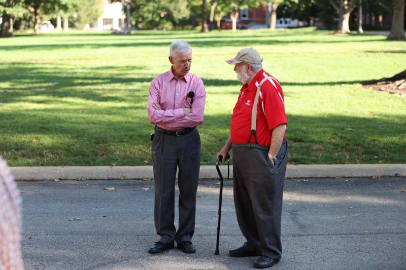 two men standing on the street