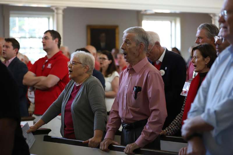 a group of people singing in a room