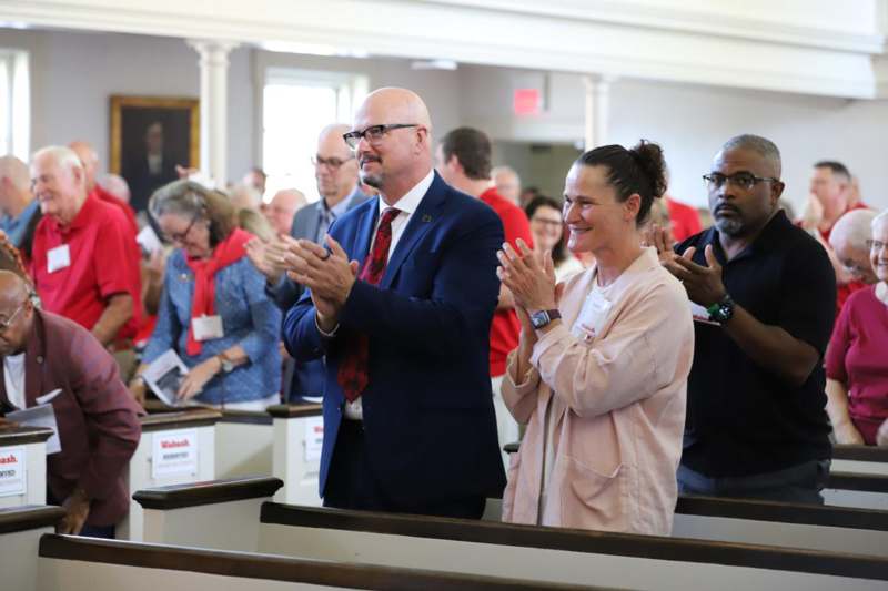 a group of people clapping in a church