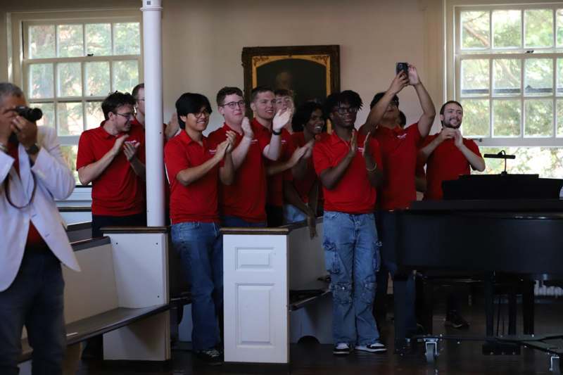 a group of people in red shirts