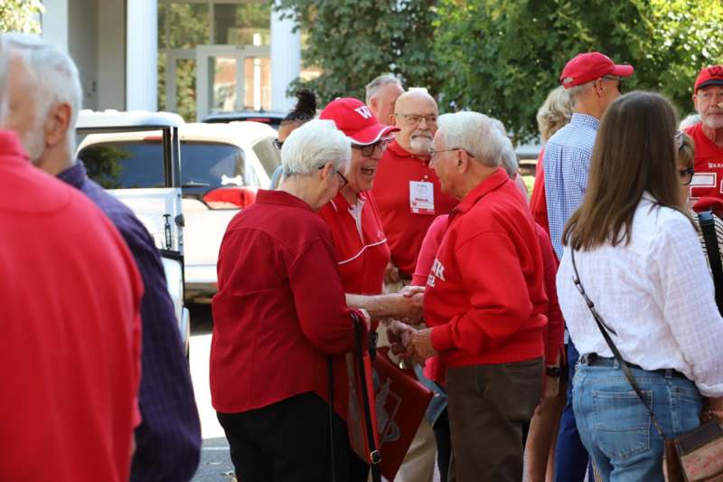 a group of people in red shirts