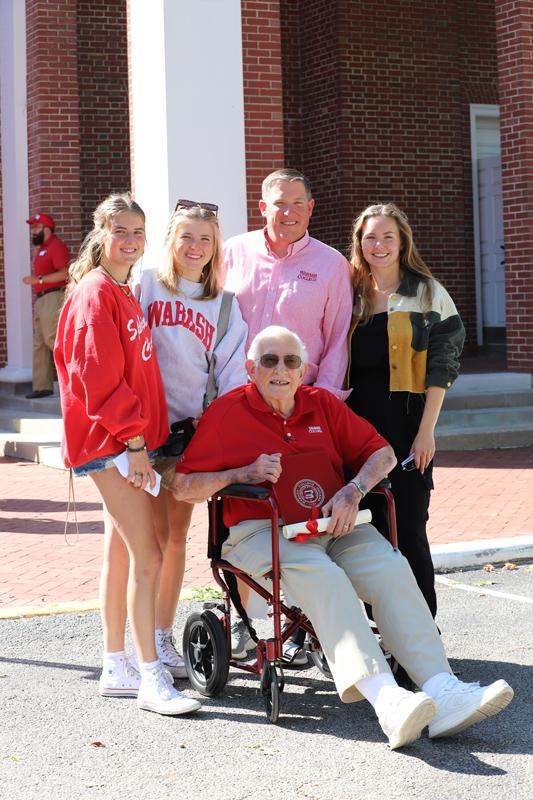 a man in a wheelchair with a group of people