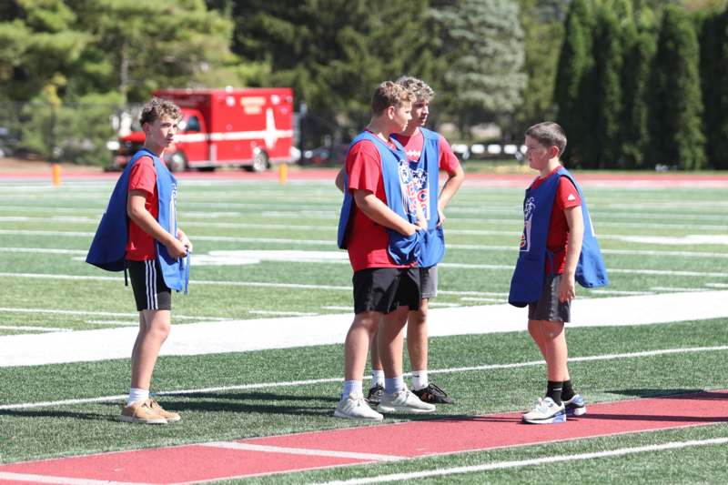 a group of boys standing on a field