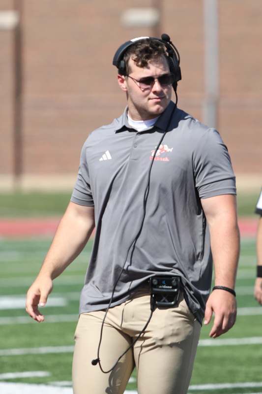 a man walking on a football field
