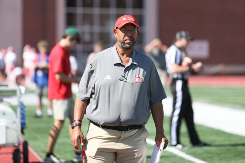 a man in a red hat standing on a football field