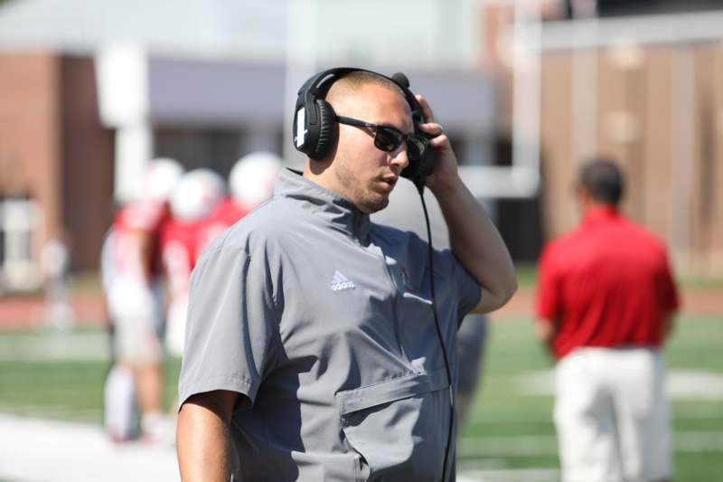 a man wearing headphones and talking on a headset