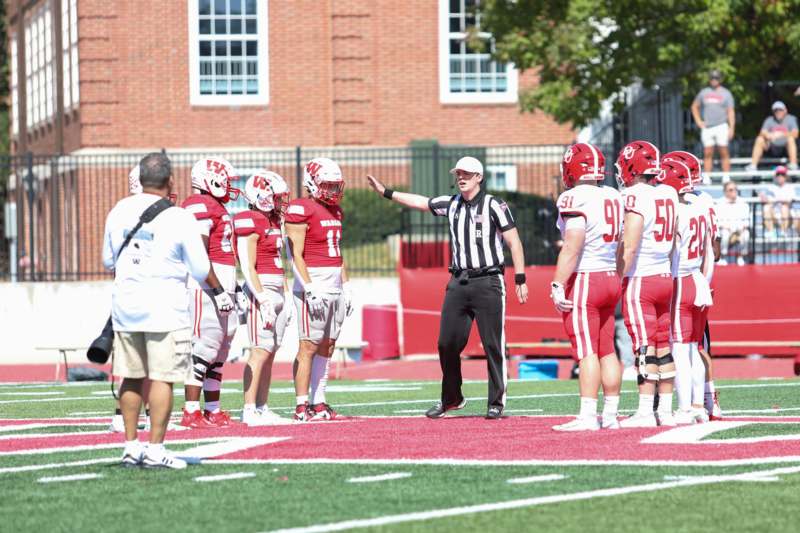 a football coach with his players on a field