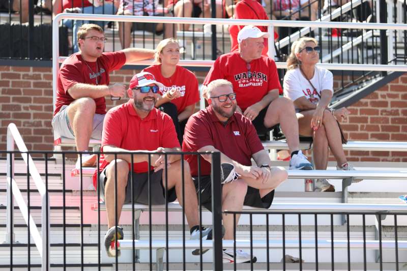 a group of people sitting on bleachers