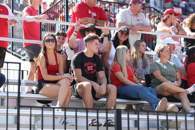 a group of people sitting on bleachers