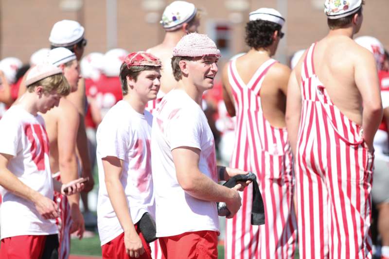 a group of people in striped uniforms