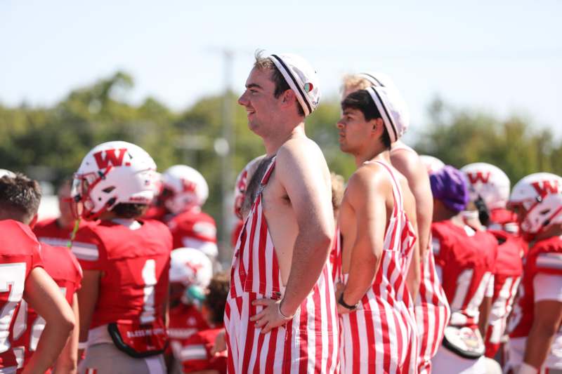 a group of people wearing striped overalls