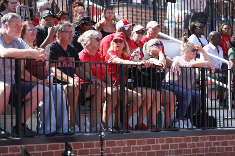 a group of people sitting on bleachers