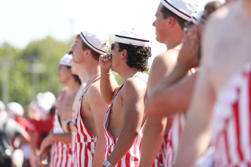 a group of men in striped overalls