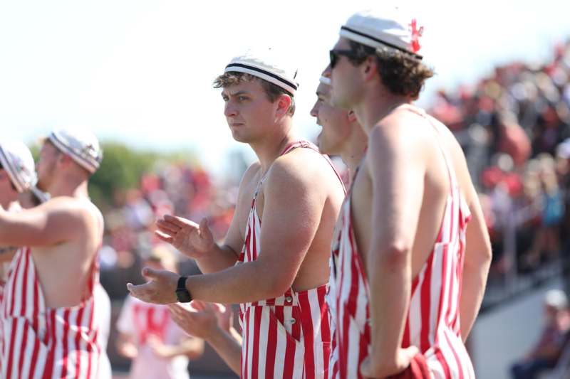 a group of men wearing striped overalls