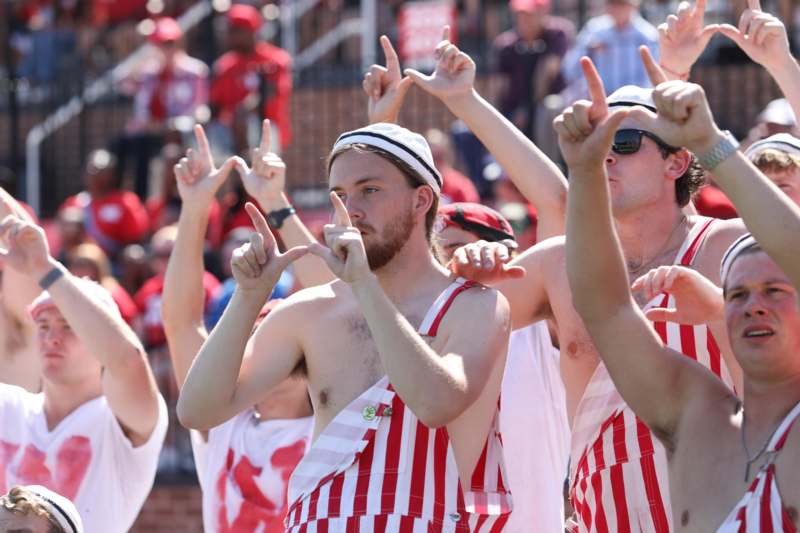 a group of men wearing red and white striped shirts